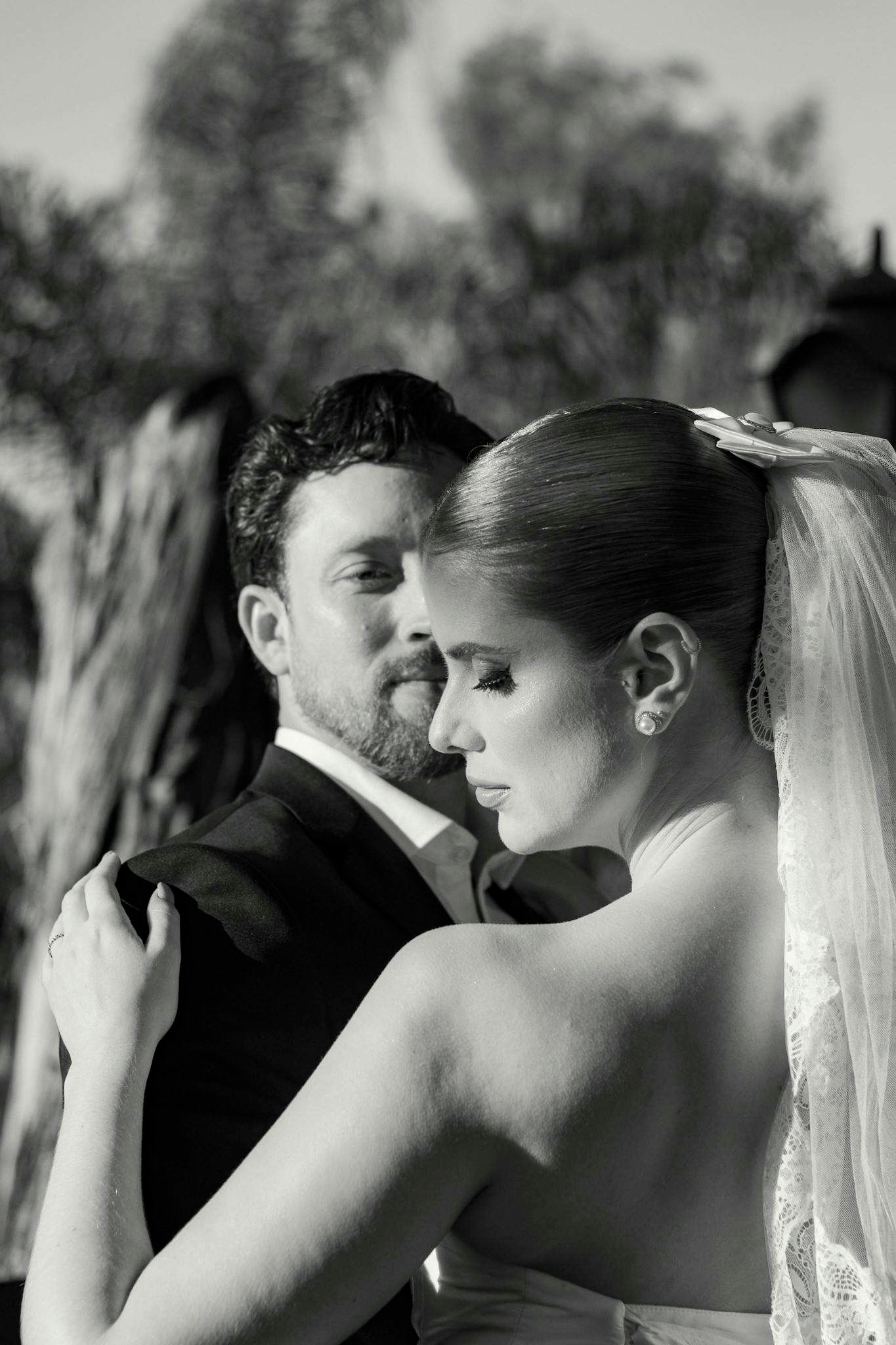 Romantic black and white image of a couple sharing a wedding dance.